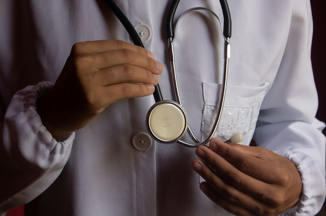Doctor examining patient with a stethoscope